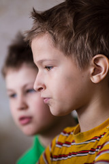 Obraz premium Two boys sitting together and watching