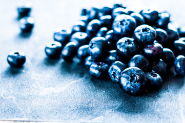 Blueberry on wooden table background. Ripe and juicy fresh picked blueberries closeup. Berries closeup