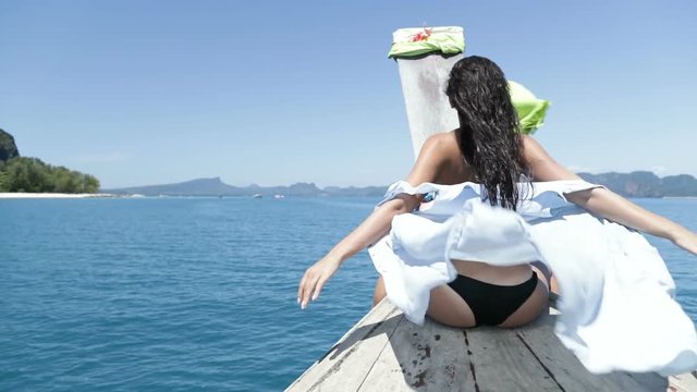 Beautiful Woman Sitting On Thailand Boat Nose, Raising Hand Back Rear View Of Young Girl Enjoy Wind Slow Motion 120