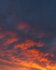 Fototapeta na wymiar Fiery vivid sunset sky clouds