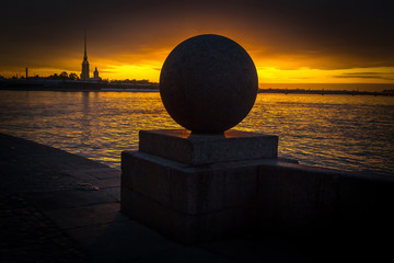 A granite ball on the arrow of Vasilievsky Island. Petersburg. Sunrise, sunset.