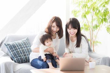 young asian family using laptop in living room