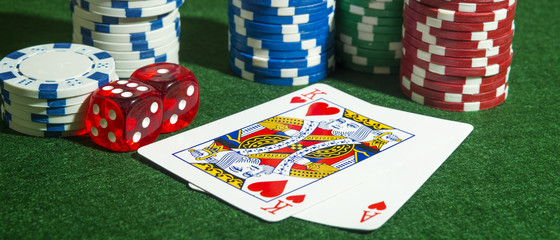 Panoramic shot of Poker Cards, chips and dice on a table. Copyspace.