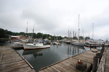 Fototapeta premium Sailboats at Dock in Camden, Maine Harbor on Cloudy Day