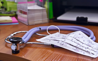 Phonendoscope and medical mask on the doctor's desk , medical instruments
