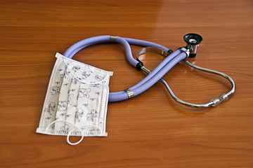Phonendoscope and medical mask on the doctor's desk , medical instruments
