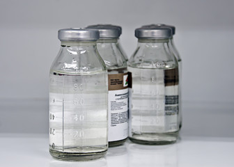 Medical bottles with saline solution, medical locker, supplies of medicines