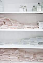 Medical bottles and packages with saline solution, medical locker, supplies of medicines