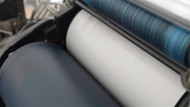 Old rusty offset machine rolls and ink printing pages