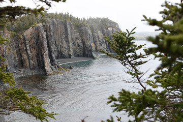 Towering cliffs in Newfoundland on a rainy, misty day
