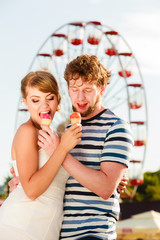 young couple eating ice cream outdoor