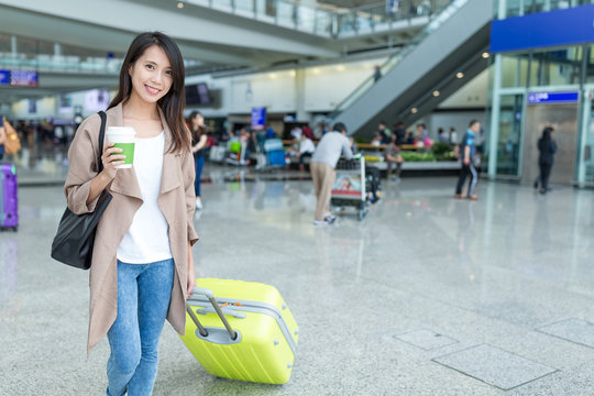 Woman go travel with luggage in Hong Kong international airport