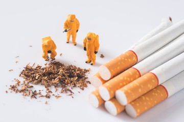 miniature technician checking contaminants in cigarette