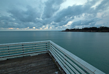 Fototapeta premium San Simeon Public Pier under sunset clouds on the Central Coast of California USA