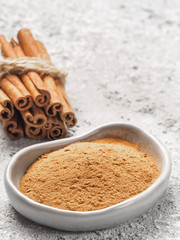 Ground cinnamon on gray background
