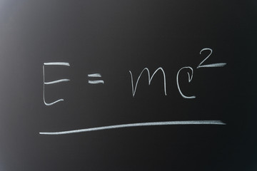 Theory of relativity formula written on chalkboard