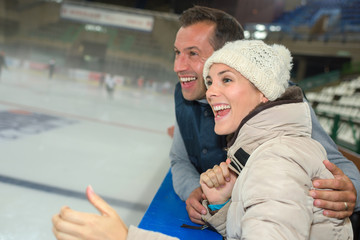 Couple supporting ice hockey team