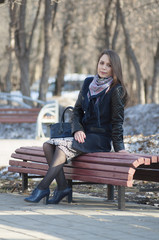 The beautiful woman smiles in the park.