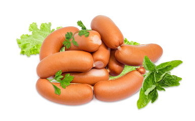 Pile of the uncooked wieners and various greens