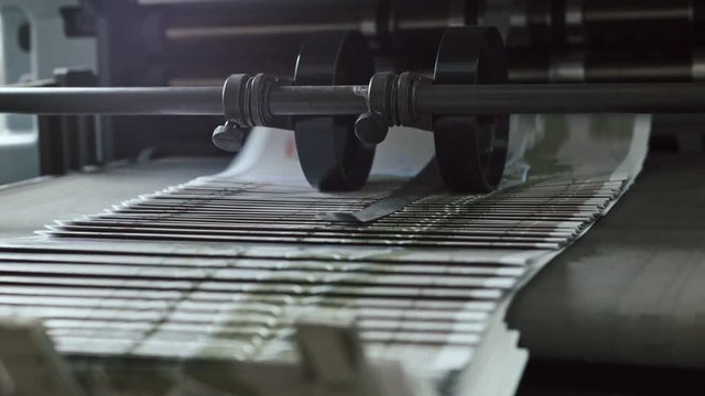 Printing Process on polygraph industry - brochures moving on the conveyor belt