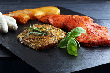 Selection of marinaded meat for grilling and sausages