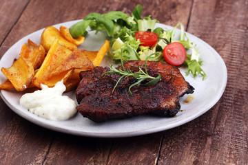 Grilled steaks, baked potatoes and salad