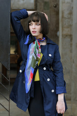 Portrait of a stylish girl near a metal railing