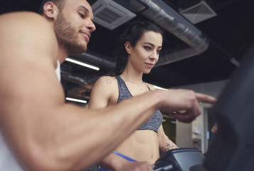 Personal trainer guiding sports woman .