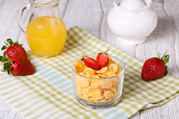 healthy breakfast with cereal flakes, strawberry, orange juice