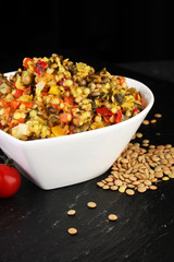 Lentil with carrot and pumpkin ragout in a wooden bowl on a wood