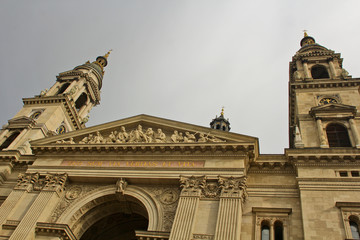 Front fragment of St. Stephen's Basilica in Budapest, Hungary. Roman catholic church in neoclassical style against the gray sky