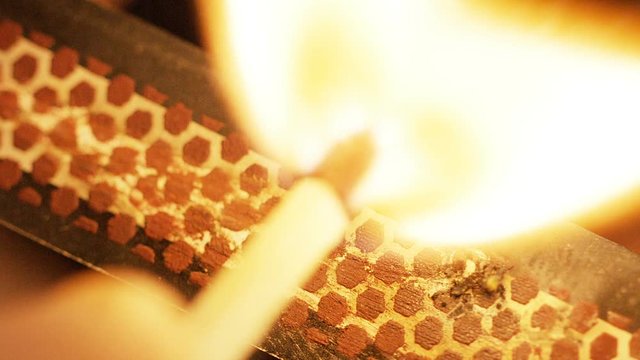 Close up shot of a match being struck, in slow motion