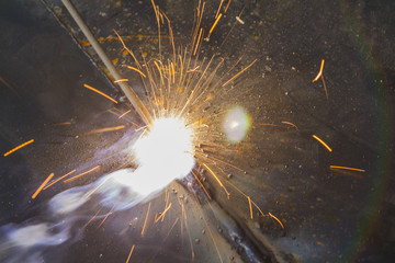 SMAW – Shielded matal arc welging and welding flame at spark  point. - obrazy, fototapety, plakaty