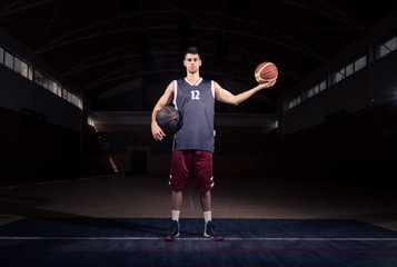 Fototapeta na wymiar basketball player holding two balls