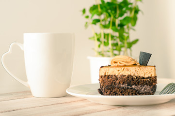 sweet cake with cup of tea on wooden table
