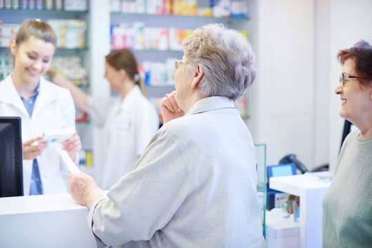 Customers been waiting on the queue in drug store.