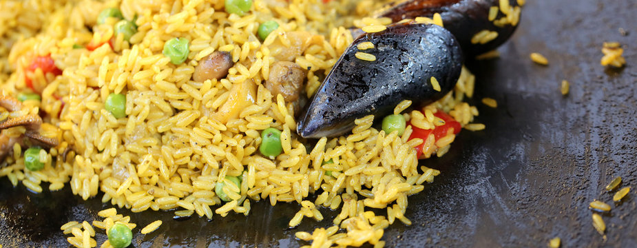 Spanish paella with mussels and tasty yellow rice and seafood