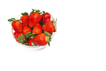 Fresh strawberry in a bowl on a white background, isolated top view. Copy space for text. Summer health concept