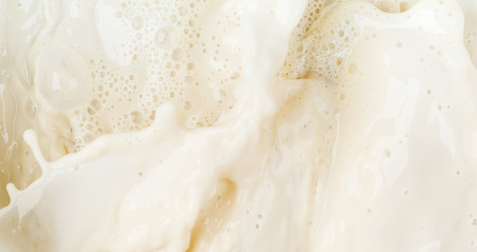 Soy milk splash motion and bubble foam on top view background