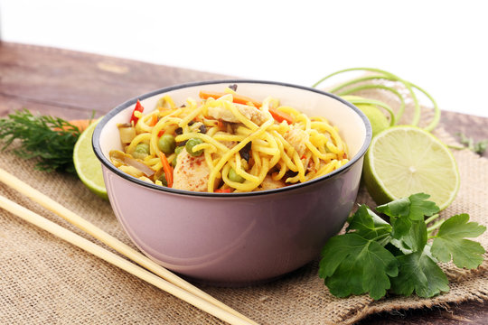 Traditional indonesian meal bami goreng with noodles, vegetables and chicken
