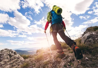 Plexiglas foto achterwand Traveler feet hiking in mountains on sunset © Mediteraneo