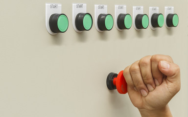Fist smash touch on red emergency stop switch and reset with green start buttons for stop machine.