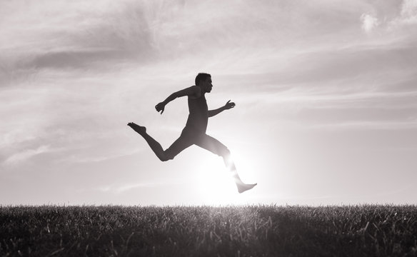 Running Fast! Silhouette Of Man Sprinting To The Finish Line. 