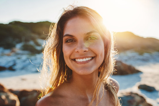 Smiling young woman on the beach