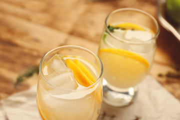 Refreshing cocktails with lemon on wooden table