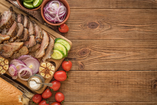 Sliced grilled meat barbecue on cutting board with vegetable  .