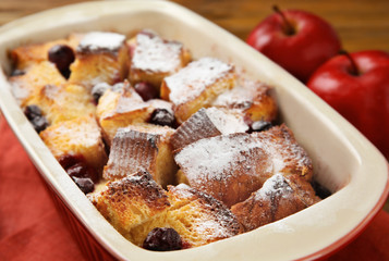 Freshly baked bread pudding in casserole dish, closeup