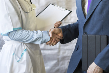 Business handshake. Businessman shaking hands with doctor shaking hands