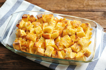 Delicious bread pudding with raisins in glass dish