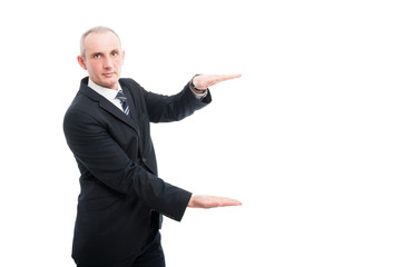 Portrait of aged elegant man holding copy space